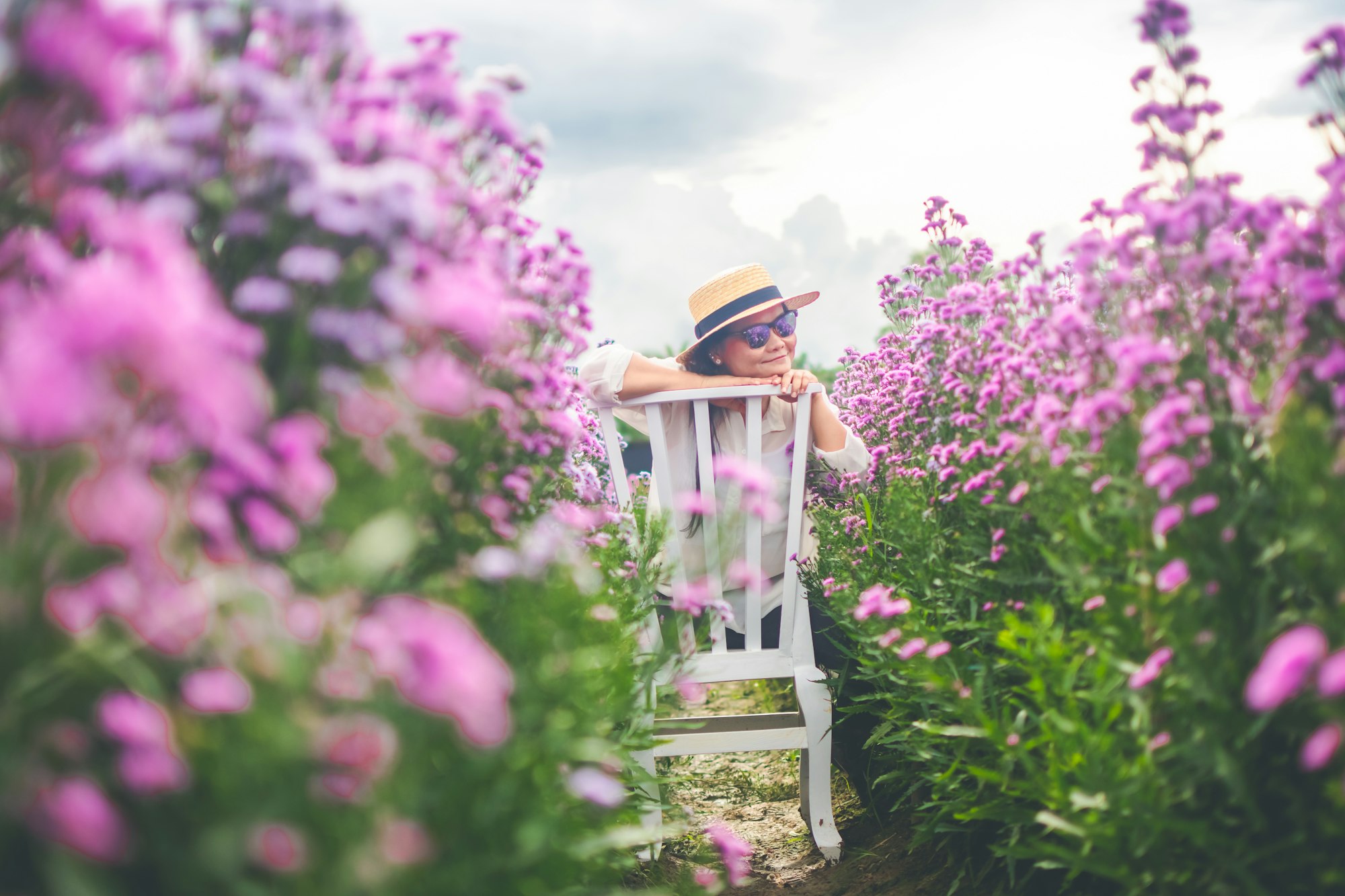 asian woman stand in the margaret garden flower.